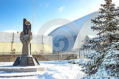 Chernobyl Reactor â€“ sarcophagus to contain the radioactive materia and Monument to the dead at the Chernobyl nuclear power plant Editorial Stock Photo